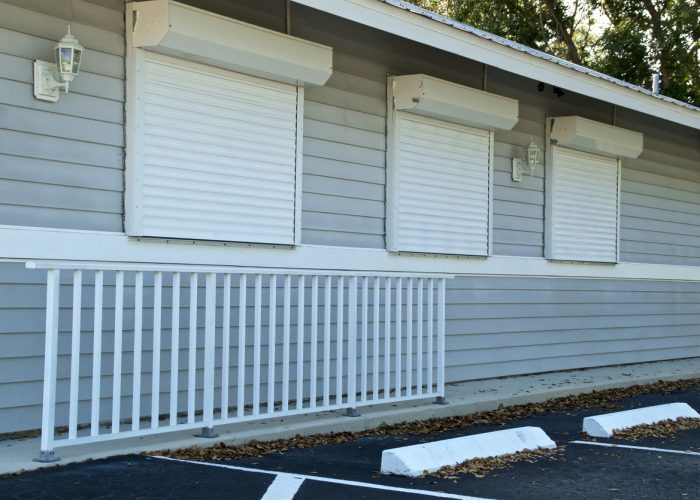 View of small generic florida building with hurricane shutters closed.